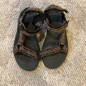 Brown and black teva water shoes